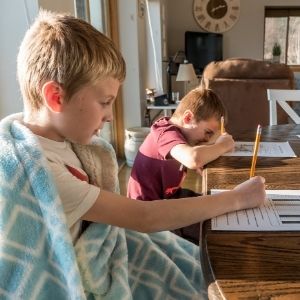 Large family homeschooling at table
