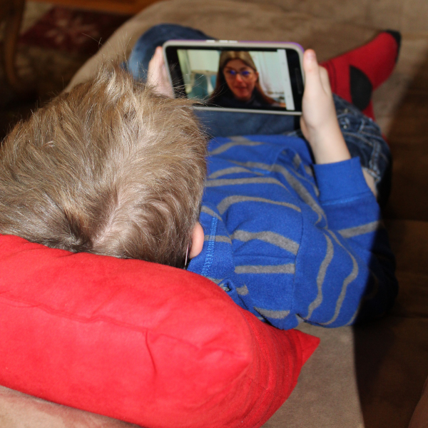 child laying on couch watching Dr. Robin's School of Pre-Medicine