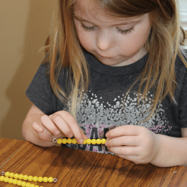 girl practicing math with Montessori Preschool for Homeschool with Sonlight