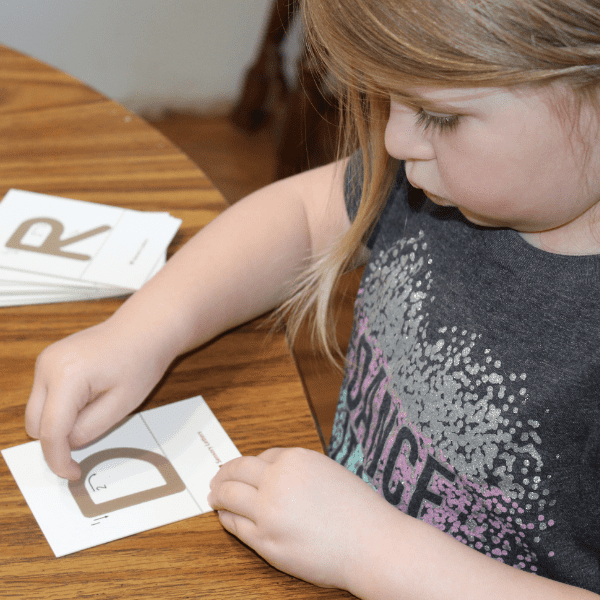girl using Montessori materials from Montessori Preschool for Homeschool with Sonlight