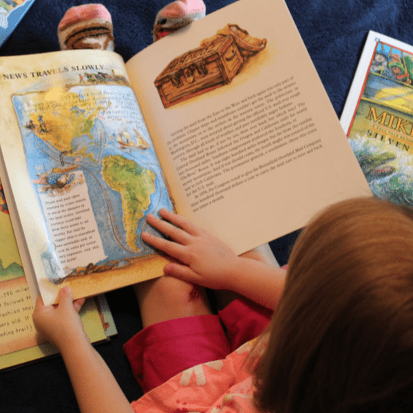 girl reading from her Charlotte Mason Homeschool Geography Curriculum from Beautiful Feet Books