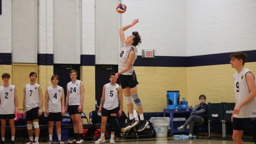 college students playing volleyball