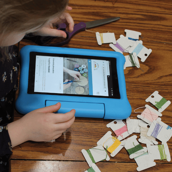 girl making friendship bracelets with homeschool life skills curriculum