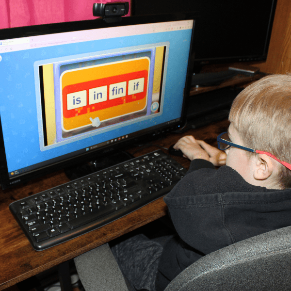 child practicing reading with his online homeschool in kindergarten