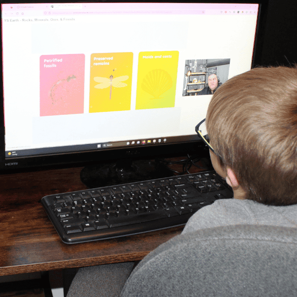 student learning about fossils with his middle school science curriculum in homeschool