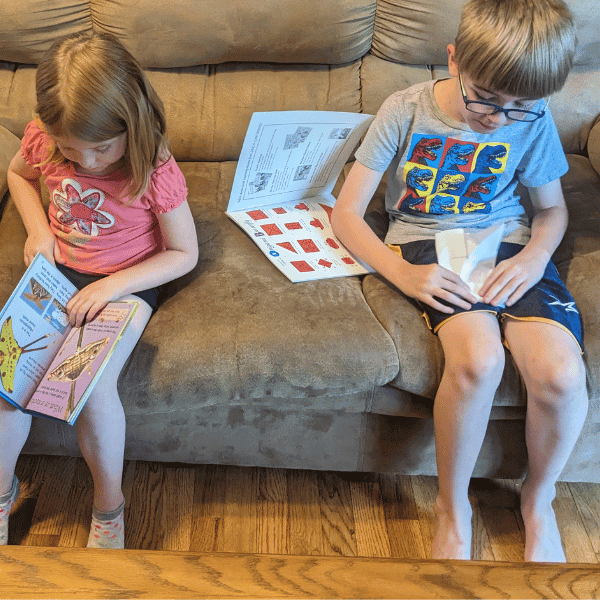 kids reading books from Sonlight's Butterfly Unit Study for homeschool