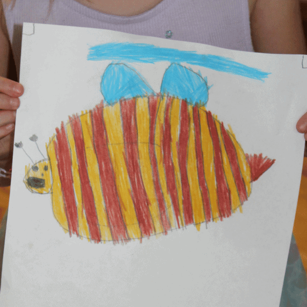 homeschool student sharing her completed art project